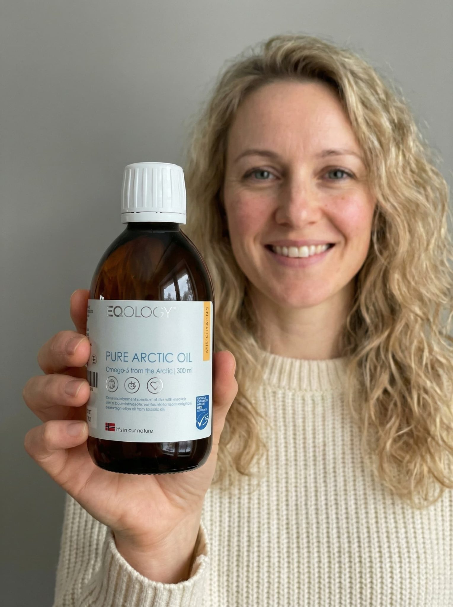 a women holding eqology product